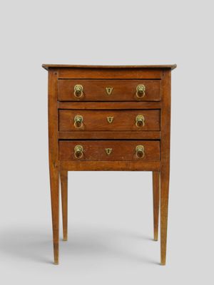 an image of a small wooden chest of drawers with brass handles