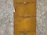 an overhead view of a piece of metal on the ground