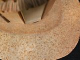 a close up of a paper hat with a brush in it