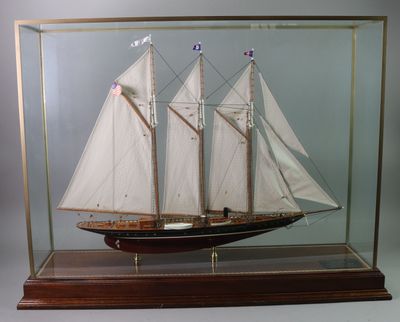 a model of a sailboat in a glass case