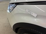 a close up of a white car with a sticker on it