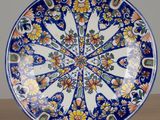 a blue and white plate with a flower design on it