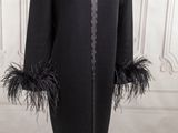 an image of a black coat with black feathers on it