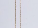 a necklace with a blue stone on it on a white surface