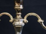 a silver candle holder on a black background
