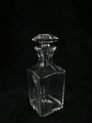 clear glass decanter on a black background with a black background