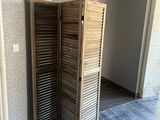 a room that has a wooden screen in the corner of it