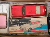 three toy cars in a box on top of each other