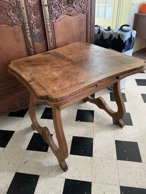 a wooden table that is sitting on a checkered floor
