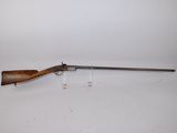 a rifle on a white surface with a white background