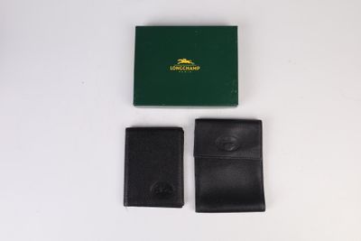 deux portefeuilles en cuir noir et une boîte verte posés sur une surface blanche