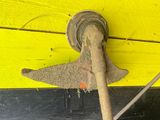 a yellow and black wooden wall with a metal hook