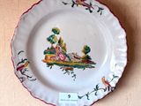 a plate with a picture of a woman and a dog on it