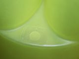 a close up view of a green bowl with a lid
