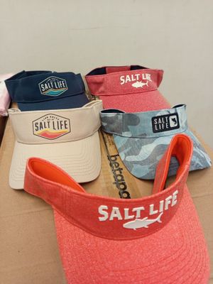 several hats that are sitting on top of a cardboard box