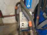a machine that has a hose attached to it in a garage