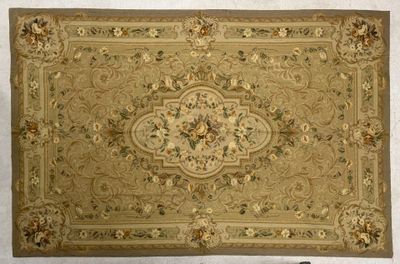 beige area rug with a floral design on a white background