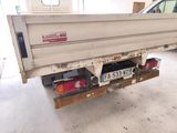 a white truck with a number plate on the back of it