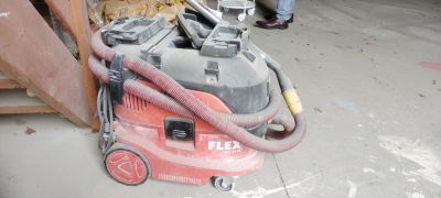 a red vacuum cleaner that is sitting on the floor