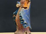 an old statue of a woman holding a baby in her arms