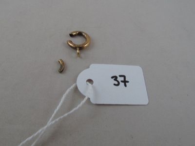 a tag with a number on it next to a pair of earrings