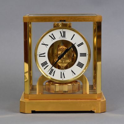a gold clock with roman numerals on it