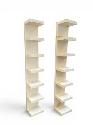 two white bookshelves with shelves on each side of each other