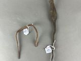 a small stick and a small stick with a tag on it
