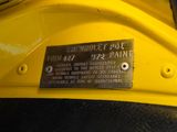 a close up of a sign on a yellow motorcycle
