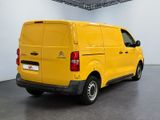 the yellow van is parked in the large room of the building