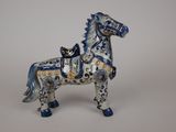 a blue and white horse figurine on a white background