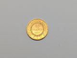an image of a gold coin sitting on top of a white surface