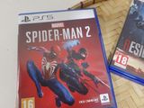 spider - man 2 and spider - man ps3 games on a table