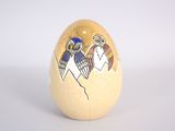 a wooden egg with an image of two birds on it