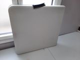 a white suitcase sitting on a white table next to a window