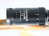 a close up of a camera lens on a wooden stick