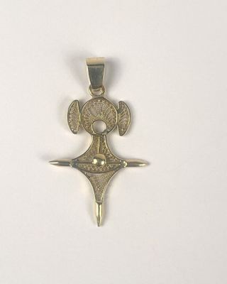 a silver cross with a star on it on a white surface