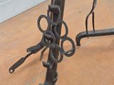 two pairs of scissors on a stand on the floor