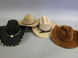 several hats are lined up on a table with a white background