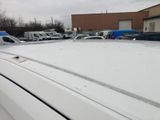cars parked in a parking lot with snow on the roof