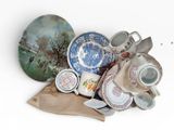 a pile of dishes and cups sitting on a table