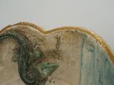 a vase with a lizard on it sitting on a table