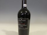 the bottle of red wine is sitting on the table