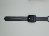 an apple watch sitting on top of a table next to a book