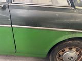 a green and black car that is parked on the street