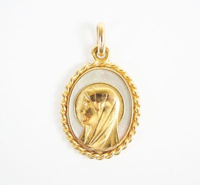 an image of a gold pendant with a woman in a veil