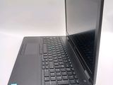 a laptop computer sitting on a table with a keyboard