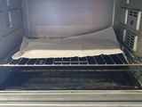 a small oven that has a sheet of paper in it