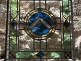 a stained glass window on the wall of a building