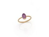 a gold ring with a purple stone in the middle